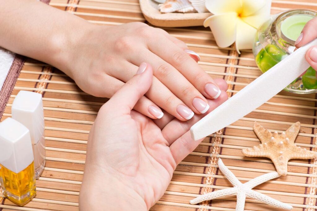 hand finger nail file during nail care session
