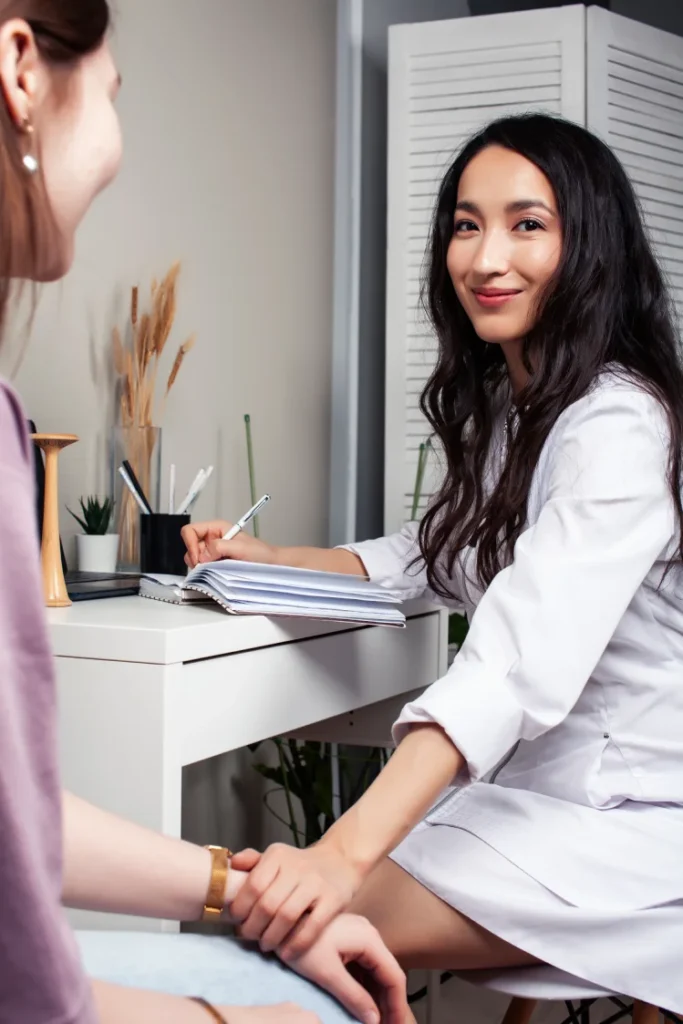  a therapist giving consultation to her client in need of a womb massage 